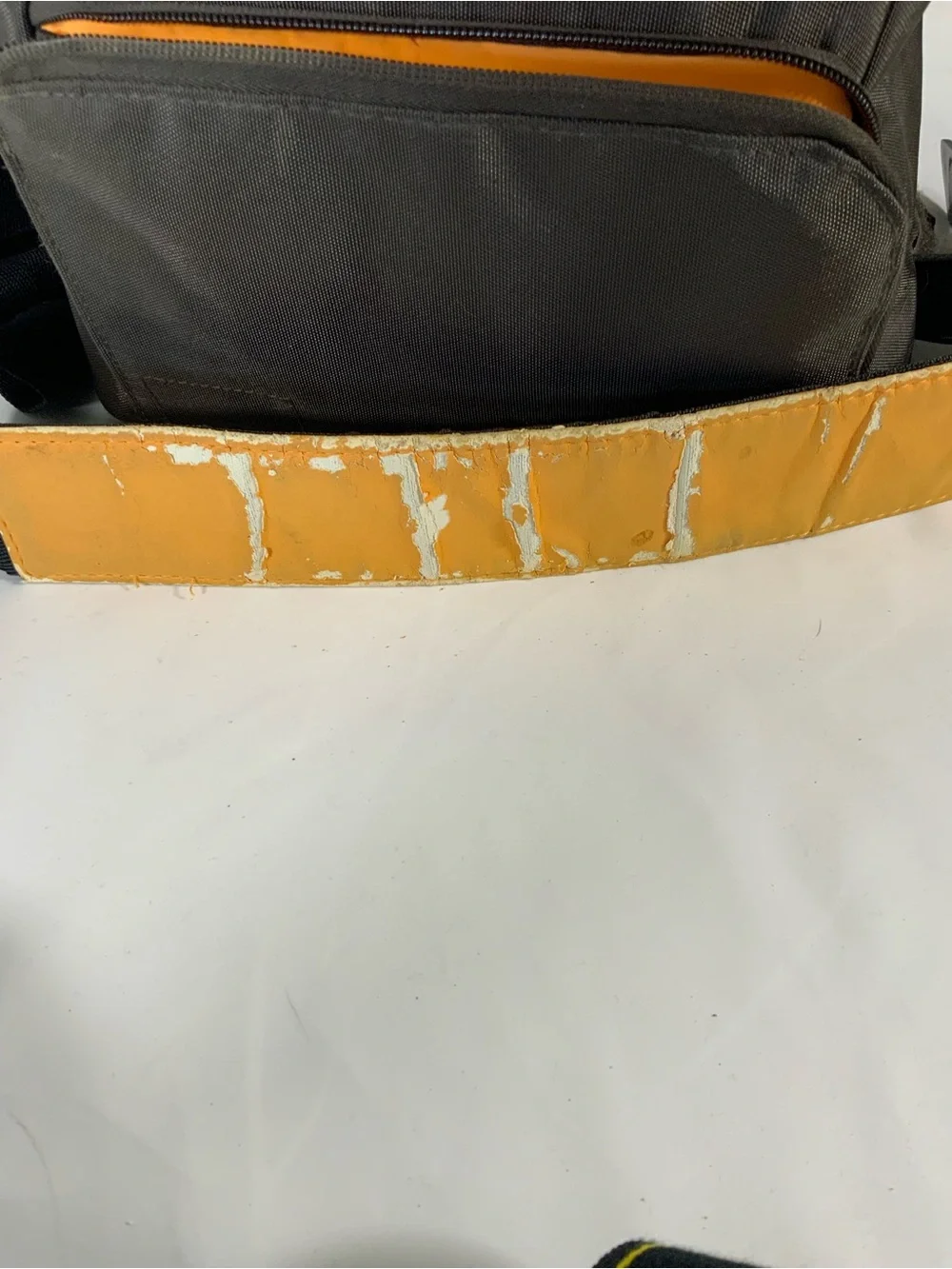 Nikon DSLR Camera with Black Body and Yellow-Orange Interior Bag